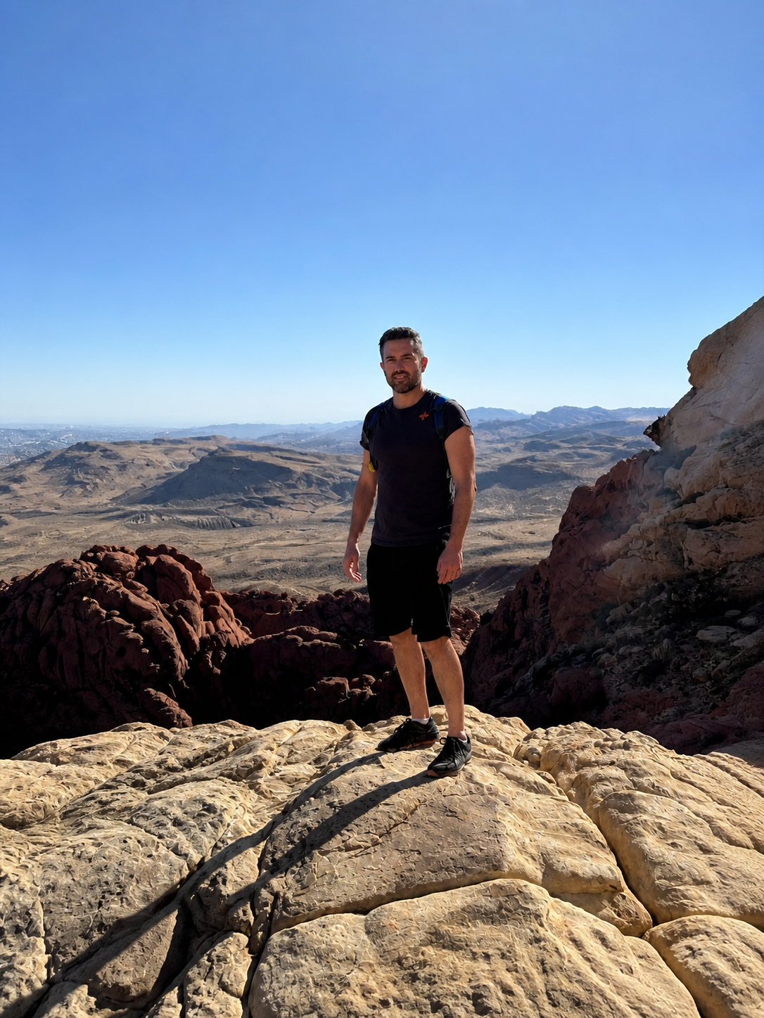 Aaron Lowe hiking on a rocky mountain overlook